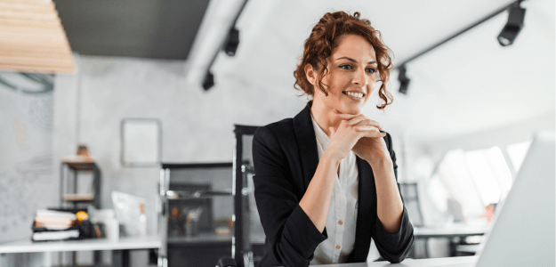 Communication: Young lady sitting at desk and smiling - Launchup Support Coordinations